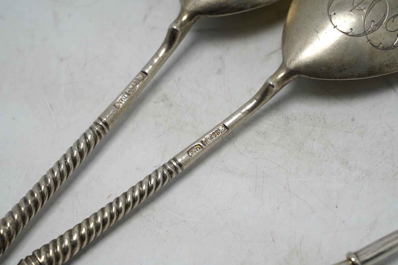 A pair of late 19th century Russian 84 zolotnik serving spoons, Moscow, 1896, 18.8cm, and two other smaller Russian 84 zolotnik and niello spoons. Condition - fair